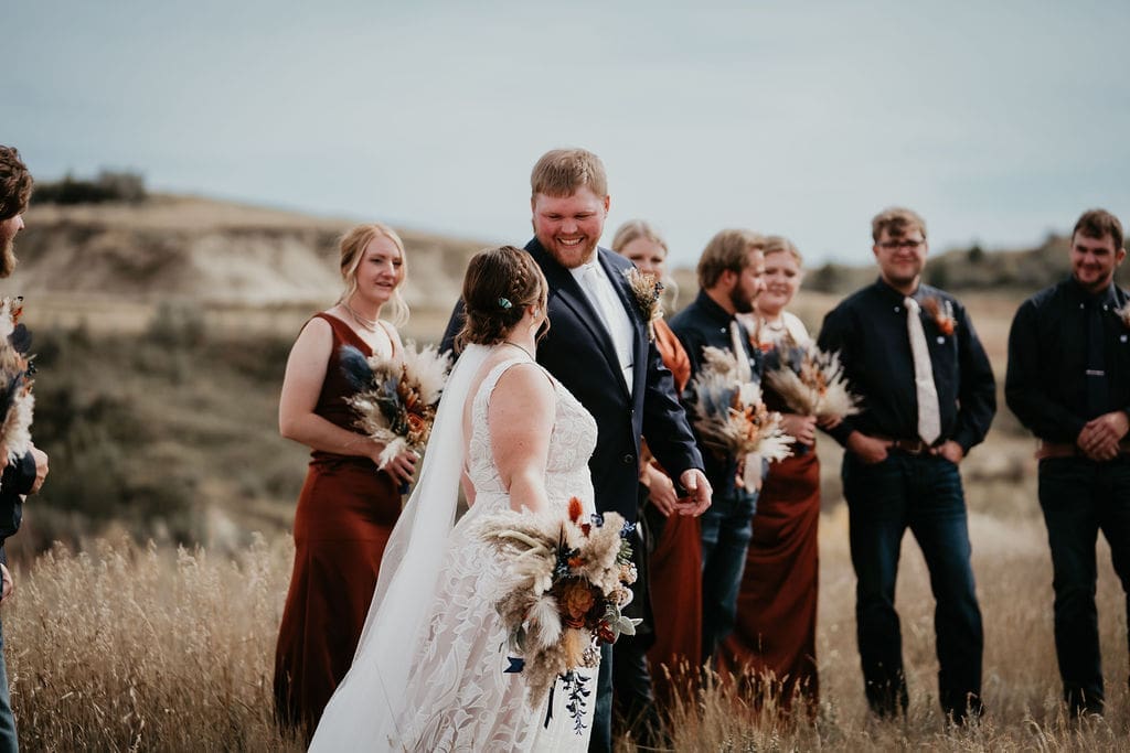 Bride and groom walking together with bridal party at Buffalo Gap wedding captured by Belfield wedding photographer