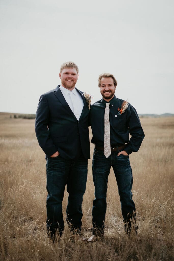 Groom standing with groomsman in wide open prairie at Belfield North Dakota wedding