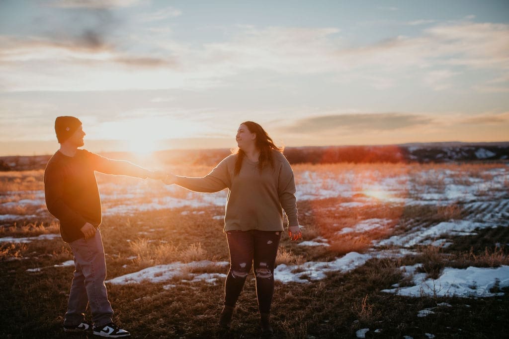 Bride and groom dancing outside in golden hour light in Billings
