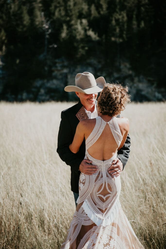 Couple laughing together during sunset ranch wedding portraits in Eastern Montana.