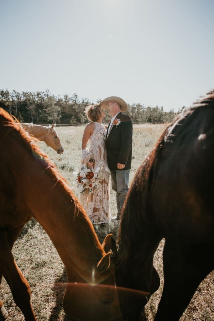 Montana ranch wedding with horses grazing in the background captured by Chelise Boysun Photography.