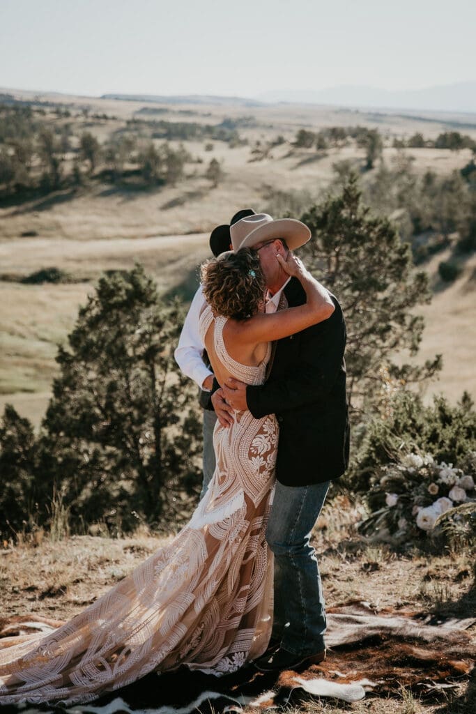 Couple shares first kiss at outdoor ranch ceremony photographed in Eastern Montana.