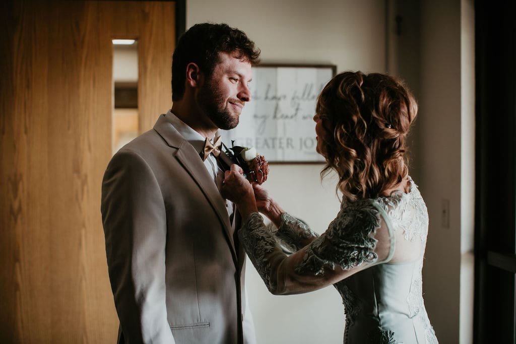 Close-up of groom’s boutonniere before first look in downtown Billings