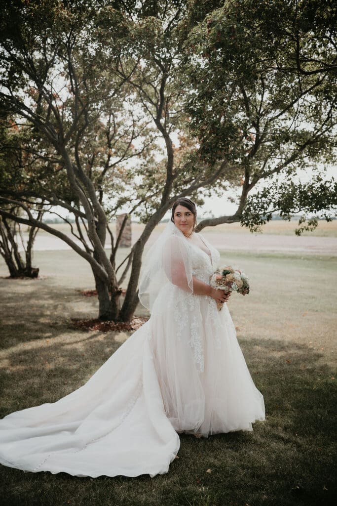 Bride’s lace dress catching light during portraits in Billings
