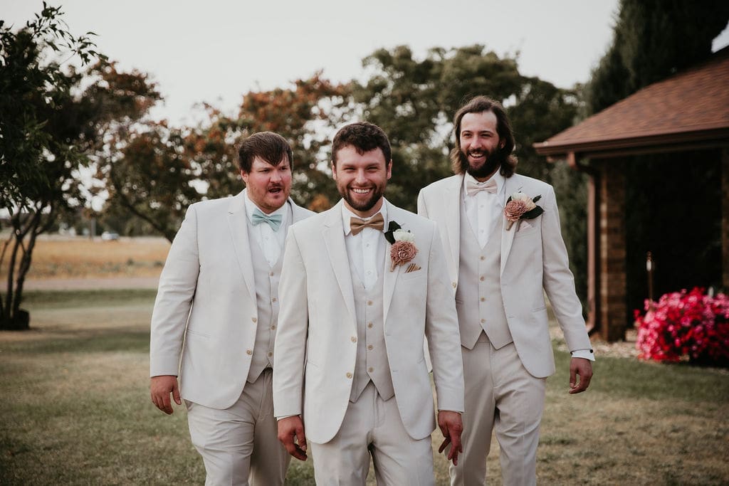 Groomsmen standing in field near Billings for group photo