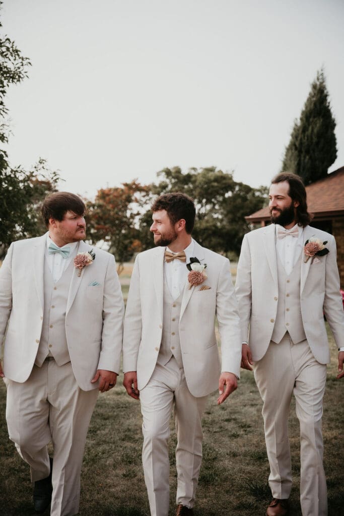 Groom and best man sharing a candid laugh outside the venue