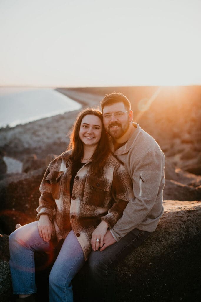 Scenic engagement photo of a couple walking along the ridge overlooking the valley.