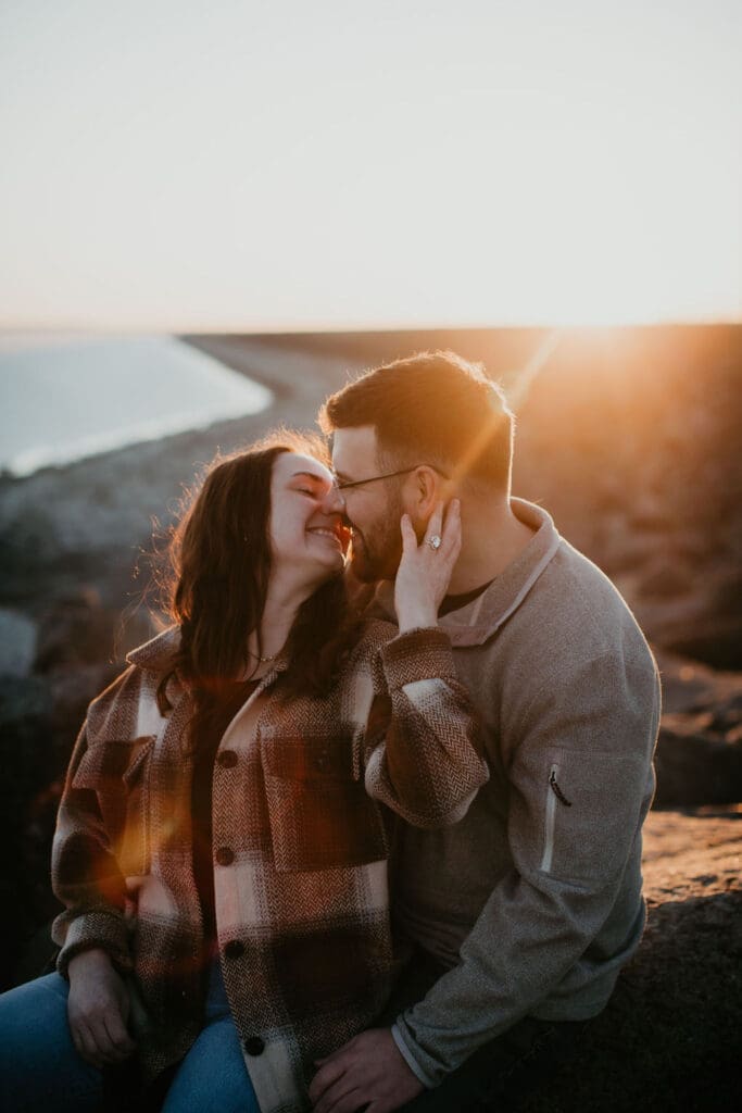 Playful engagement moment with wind blowing through the prairie grass at sunset.