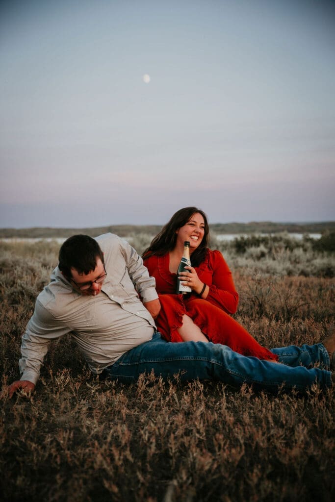 Couple celebrating their engagement with Montana sunset in the background